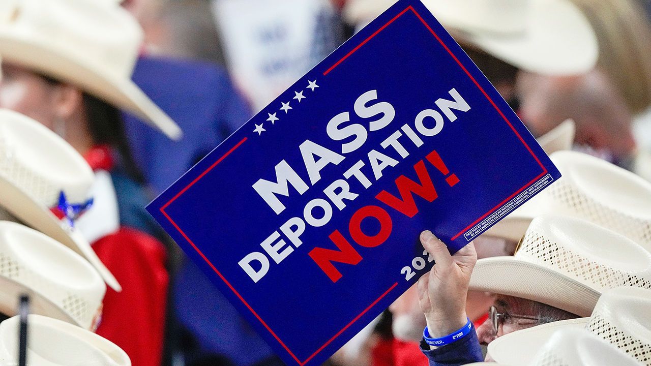 A Mass Deportation Now sign is held up at the Republican National Convention