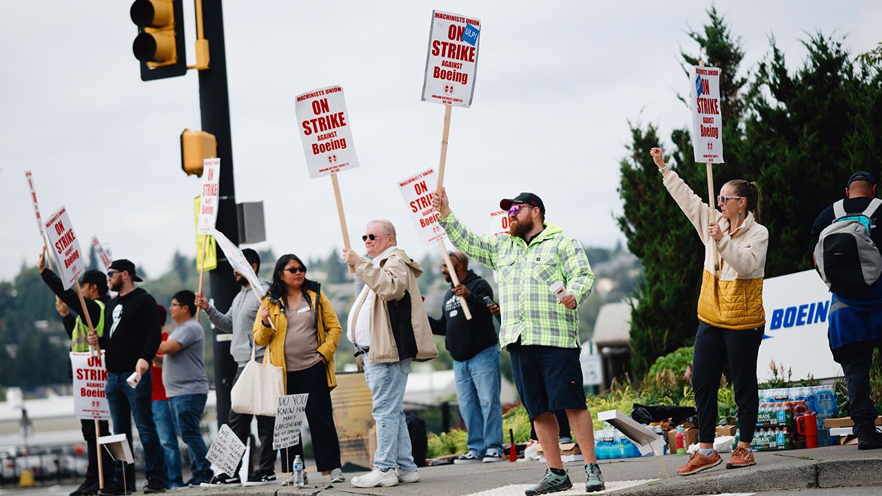 Striking workers picket outside of a Boeing production facility