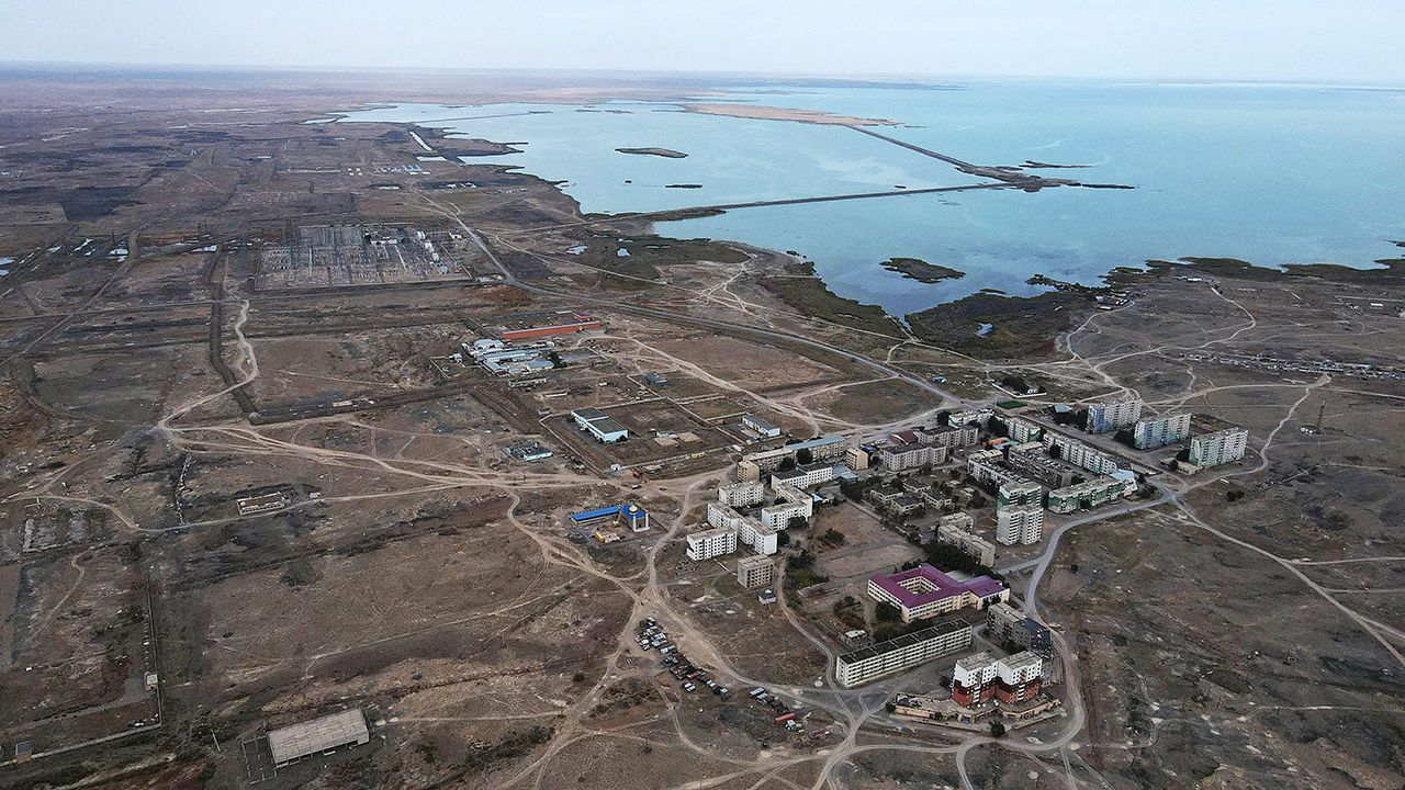 An aerial view shows the village of Ulken (foreground) and the proposed nuclear power plant site.